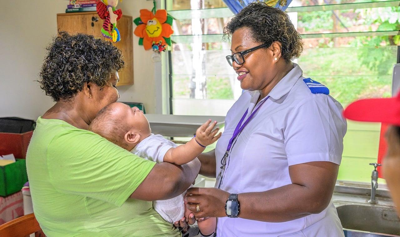A mother and her baby during a consultation with nurse Adi Elcasi Dawale at Yalobi Nursing Station, Waya Island.